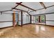 Spacious bedroom features hardwood floors, exposed beam ceiling, and natural light from double-hung windows at 203 Lakeland Dr., Conway, SC 29526