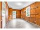 Bonus room with wood-paneled walls, tile floor, exterior door and access to another room at 203 Lakeland Dr., Conway, SC 29526
