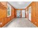 Bonus room with wood-paneled walls, tile floor, and natural light from the window and exterior door at 203 Lakeland Dr., Conway, SC 29526
