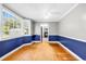 Dining room with wood floors, large windows, and connecting access to the kitchen at 203 Lakeland Dr., Conway, SC 29526