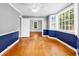 Open dining room with hardwood floors, large windows, and neutral paint at 203 Lakeland Dr., Conway, SC 29526