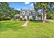 Charming two-story home with dormers, landscaped yard, and inviting front porch, creating a welcoming curb appeal at 203 Lakeland Dr., Conway, SC 29526