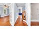 Hallway with light blue walls, with hardwood floors and a staircase with wood railing at 203 Lakeland Dr., Conway, SC 29526