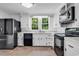 Well-lit kitchen with black appliances, white cabinets, and tile flooring at 203 Lakeland Dr., Conway, SC 29526