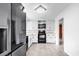 Well-lit kitchen featuring white cabinets, modern appliances, and tile flooring at 203 Lakeland Dr., Conway, SC 29526