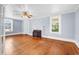 Hardwood flooring, fireplace, neutral paint, and bright windows are featured in this living room at 203 Lakeland Dr., Conway, SC 29526