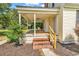 Inviting covered porch with brick steps, wood railing, ceiling fan, and siding at 203 Lakeland Dr., Conway, SC 29526