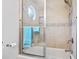 Bathroom with combined bathtub and shower, mosaic tiles, and a frameless glass door at 208 Millwood Dr., Surfside Beach, SC 29575