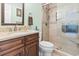 Full bathroom with a granite countertop, framed mirror and glass enclosed shower at 208 Millwood Dr., Surfside Beach, SC 29575