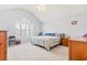 A cozy bedroom features a vaulted ceiling, carpeted floor and plantation shutters for added privacy and style at 208 Millwood Dr., Surfside Beach, SC 29575