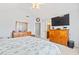 A serene bedroom features a vaulted ceiling, large windows, and an en-suite bathroom for ultimate comfort at 208 Millwood Dr., Surfside Beach, SC 29575