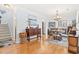 Open dining area with a chandelier, wood floors, storage and natural light at 208 Millwood Dr., Surfside Beach, SC 29575