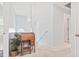 Hallway landing featuring light blue walls, a small desk, and a window for natural light at 208 Millwood Dr., Surfside Beach, SC 29575