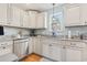 Well-lit kitchen features updated appliances, granite countertops, and ample cabinet space for storage and meal preparation at 208 Millwood Dr., Surfside Beach, SC 29575