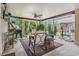 Inviting covered patio with comfortable seating, ceiling fan, and a view of the landscaped backyard at 208 Millwood Dr., Surfside Beach, SC 29575