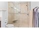 Tiled shower featuring frameless glass door, tiled walls with mosaic accents, and a built-in corner seat at 208 Millwood Dr., Surfside Beach, SC 29575