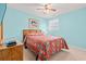Bright bedroom with blue walls, ceiling fan, and framed artwork above the bed at 212 29Th Ave. N # 204, North Myrtle Beach, SC 29582
