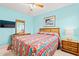 Cozy bedroom features blue walls, rattan headboard, and vintage dresser at 212 29Th Ave. N # 204, North Myrtle Beach, SC 29582