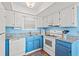 Bright kitchen featuring white cabinetry and appliances paired with light blue walls at 212 29Th Ave. N # 204, North Myrtle Beach, SC 29582