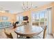 Inviting living and dining area featuring access to a balcony, laminate wood floors, and peach colored walls at 212 29Th Ave. N # 204, North Myrtle Beach, SC 29582