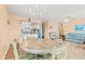 Open living and dining area with bright lighting, wood floors, and a kitchen in the background at 212 29Th Ave. N # 204, North Myrtle Beach, SC 29582