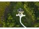 A high angle picture of a home surrounded by lush lawn and dense trees and with a curved driveway at 288 Tipperary Pl., Pawleys Island, SC 29585