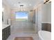 Modern bathroom featuring a walk-in shower, a soaking tub, and a view of the ocean at 288 Tipperary Pl., Pawleys Island, SC 29585