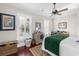 Inviting bedroom with wood floors, ceiling fan, and shuttered windows providing natural light and outdoor views at 288 Tipperary Pl., Pawleys Island, SC 29585
