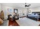 Spacious bedroom with a ceiling fan, private balcony, and comfortable seating area at 288 Tipperary Pl., Pawleys Island, SC 29585