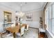 Stylish dining room featuring a decorative chandelier, wood floors, and elegant decor at 288 Tipperary Pl., Pawleys Island, SC 29585