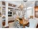 Elegant dining room with a large wooden table and adjacent living area, perfect for entertaining and Gathering gatherings at 288 Tipperary Pl., Pawleys Island, SC 29585