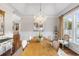 Elegant dining room with hardwood floors, bright window, and decorative chandelier at 288 Tipperary Pl., Pawleys Island, SC 29585