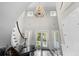 Bright, airy foyer with a grand staircase, chandelier, and black-and-white tiled floors, flooded with natural light at 288 Tipperary Pl., Pawleys Island, SC 29585