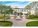 Stately home with well manicured yard, palm trees, symmetrical facade and white exterior with blue shutters at 288 Tipperary Pl., Pawleys Island, SC 29585