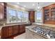Gourmet kitchen featuring granite countertops, custom cabinetry, and large windows with scenic views at 288 Tipperary Pl., Pawleys Island, SC 29585