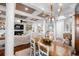 Bright open-concept living room with coffered ceilings, fireplace, built-ins, and dining table at 288 Tipperary Pl., Pawleys Island, SC 29585