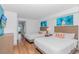 Bright bedroom featuring two beds, ocean-themed decor, and a balcony with scenic views at 3000 N Ocean Blvd. # 1127, Myrtle Beach, SC 29577