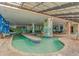 Indoor pool area with shallow water features, colorful murals, and seating creating a fun Gathering environment at 3000 N Ocean Blvd. # 1127, Myrtle Beach, SC 29577