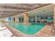 Bright indoor pool area featuring brick accents, decorative murals, and a calming atmosphere for relaxation at 3000 N Ocean Blvd. # 1127, Myrtle Beach, SC 29577
