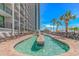 Inviting lazy river pool featuring lush landscaping and a clear view of the high-rise building at 3000 N Ocean Blvd. # 1127, Myrtle Beach, SC 29577