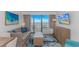 A cozy living room featuring stylish furniture, a TV, and a sliding glass door to a balcony at 3000 N Ocean Blvd. # 1127, Myrtle Beach, SC 29577