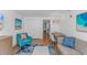 Bright living room with dining table, couch, and sliding door to balcony at 3000 N Ocean Blvd. # 1127, Myrtle Beach, SC 29577