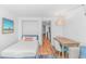 Living room, with dining table, small bed, and sliding door to balcony at 3000 N Ocean Blvd. # 1127, Myrtle Beach, SC 29577