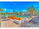 Outdoor pool area featuring slides, seating, palm trees, and a bar for endless Gathering fun at 3000 N Ocean Blvd. # 1127, Myrtle Beach, SC 29577
