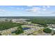 Stunning aerial shot of a community, highlighting lakes, houses and extensive greenery, set against a vibrant sky at 305 Forestbrook Cove Circle, Myrtle Beach, SC 29588