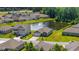 Aerial view of a lovely home overlooking a serene pond with fountain in a vibrant community at 305 Forestbrook Cove Circle, Myrtle Beach, SC 29588