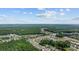 Expansive aerial view of a residential community nestled among lush green forests under a partly cloudy sky at 305 Forestbrook Cove Circle, Myrtle Beach, SC 29588