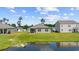 A view of the back of a house with a pond in the backyard at 305 Forestbrook Cove Circle, Myrtle Beach, SC 29588