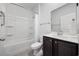 Well-lit bathroom featuring a shower-tub combo and dark wood vanity at 305 Forestbrook Cove Circle, Myrtle Beach, SC 29588