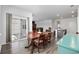Open concept floor plan showing dining area with hardwood floors, modern lighting, and back patio access at 305 Forestbrook Cove Circle, Myrtle Beach, SC 29588